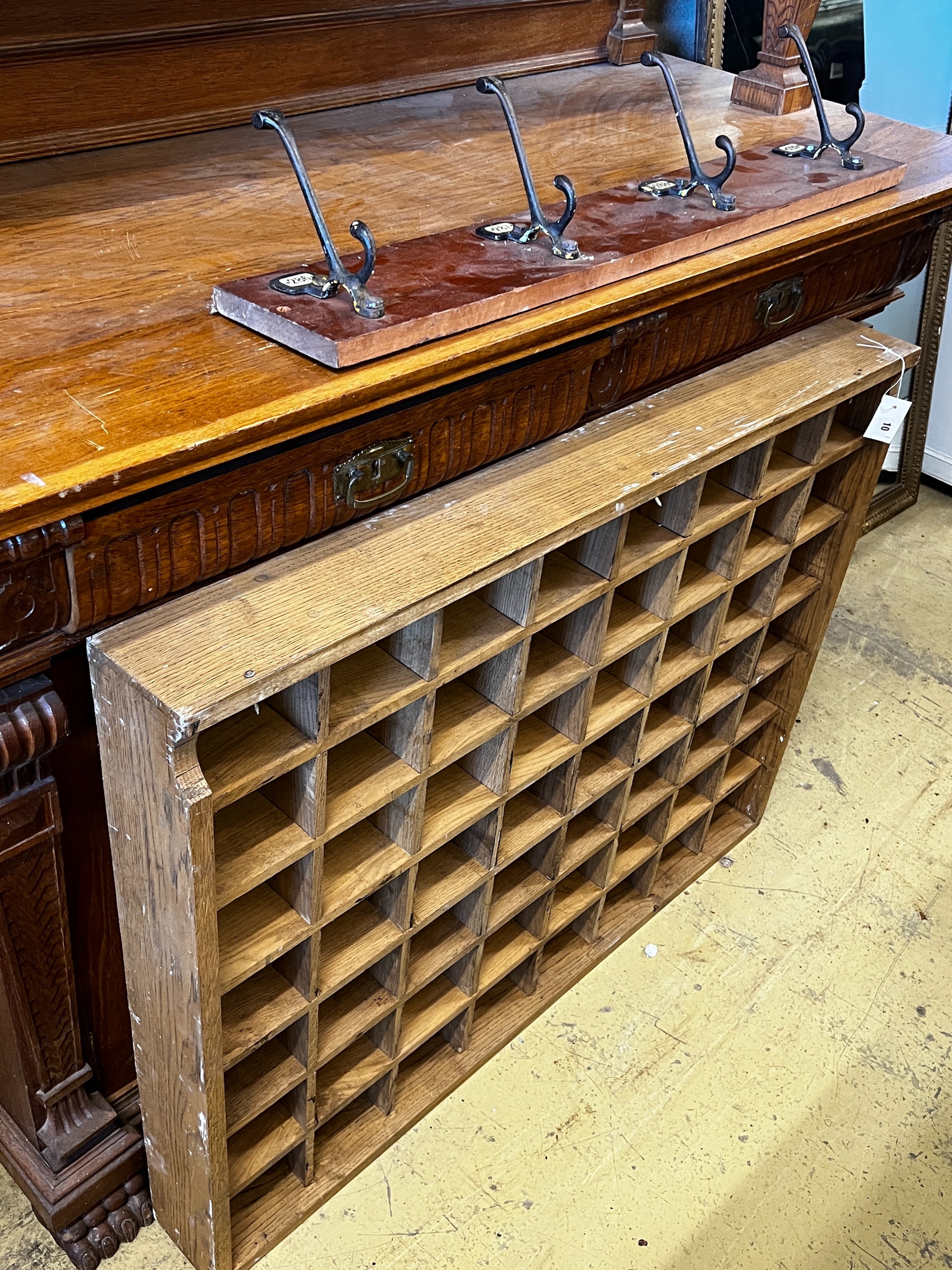 An oak pigeonhole unit, width 112cm, height 86cm together with a vintage four hook coat rack, width 86cm